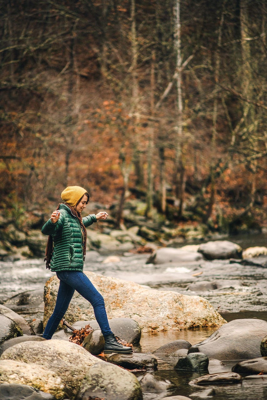 Stepping on rocks in the river in Pigeon Forge, Tennessee