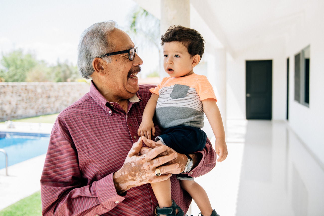 Grand father holding grandson