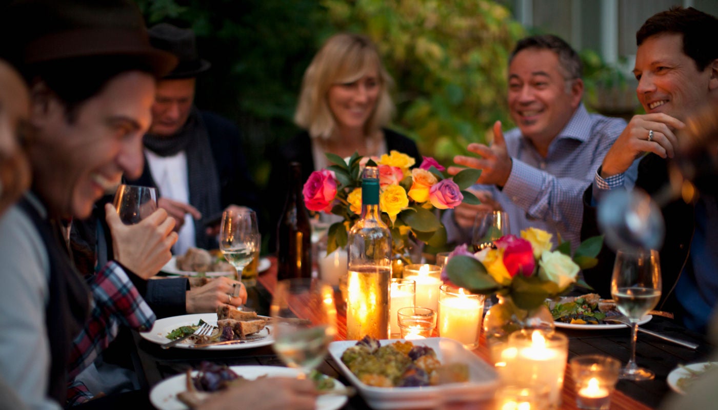 Friends gather for outdoor dinner party.