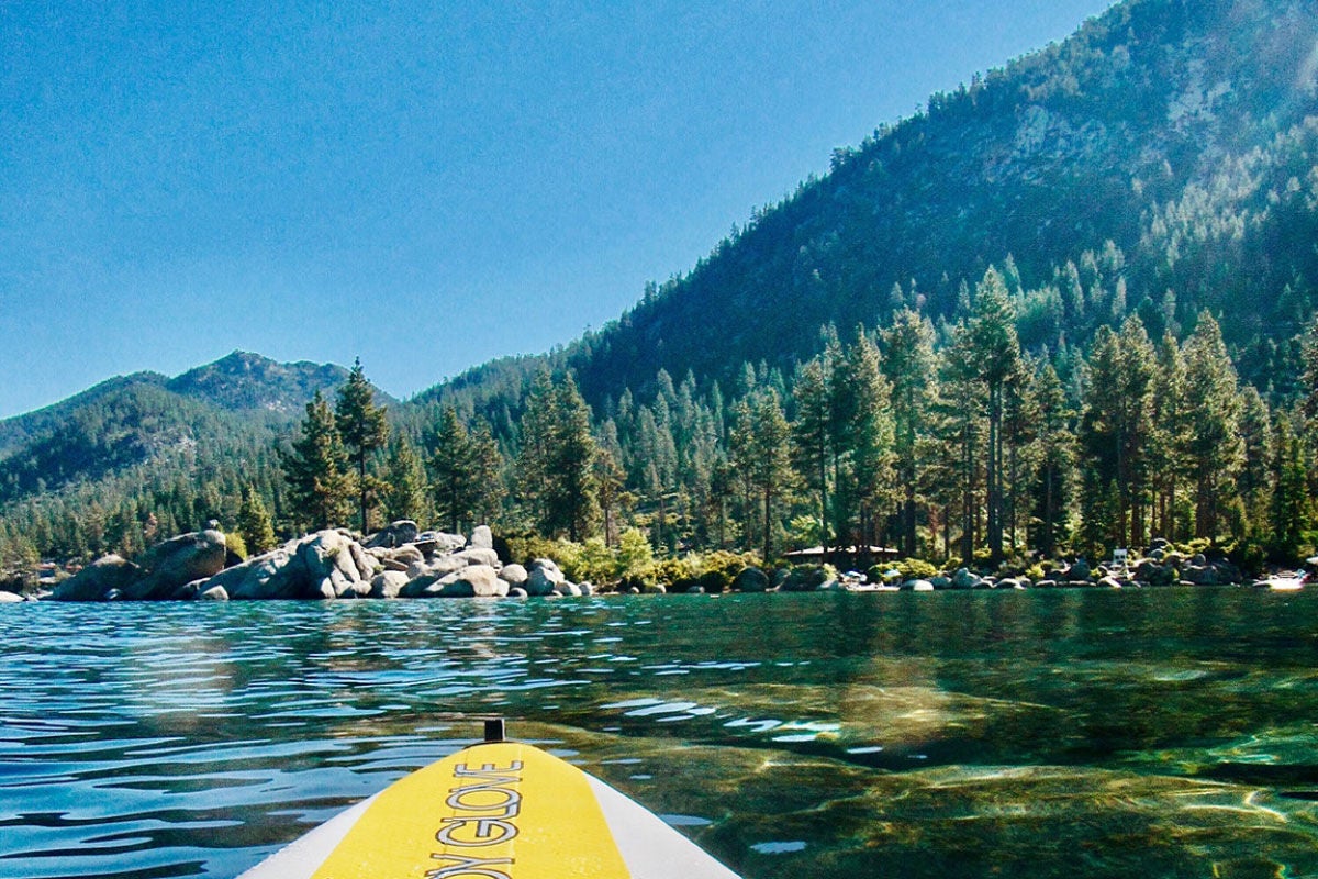 PADDLE THROUGH LAKE TAHOE'S CRYSTAL-CLEAR WATERS SURROUNDED BY MOUNTAIN PEAKS. [PHOTO CREDIT: MAKENZIE COOPER]
