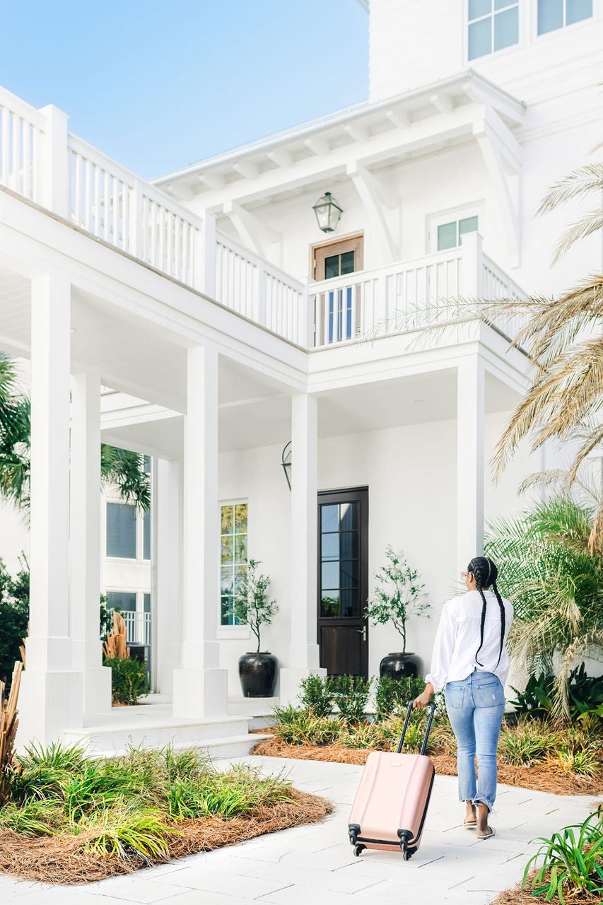 Woman walking up to vacation home