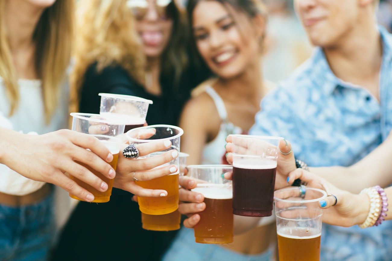 837492090 Friends drinking beer and having fun at music festival