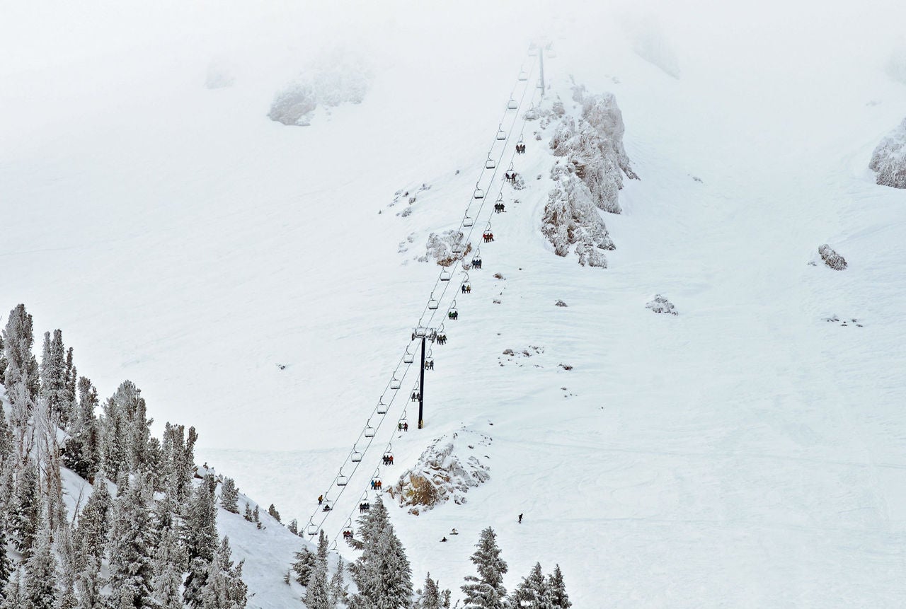 Ski lift chair ascending the mountainside