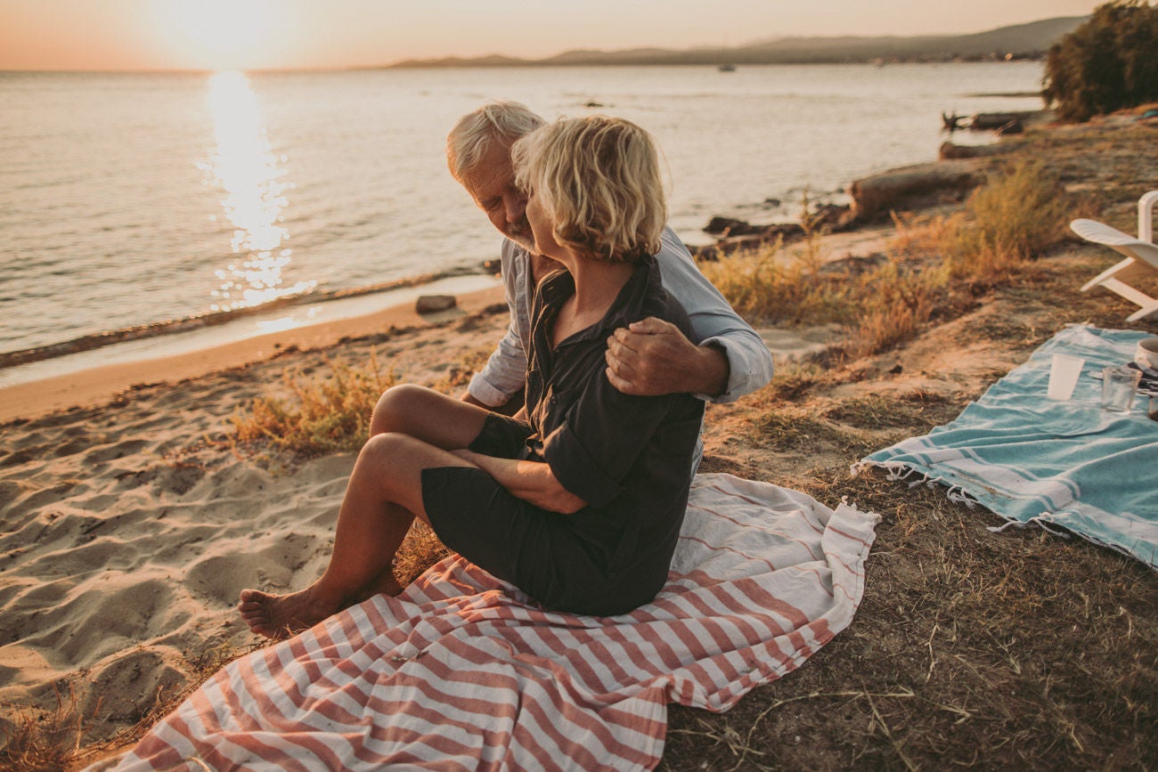 Photo of senior couple who enjoy each other during their picnic date