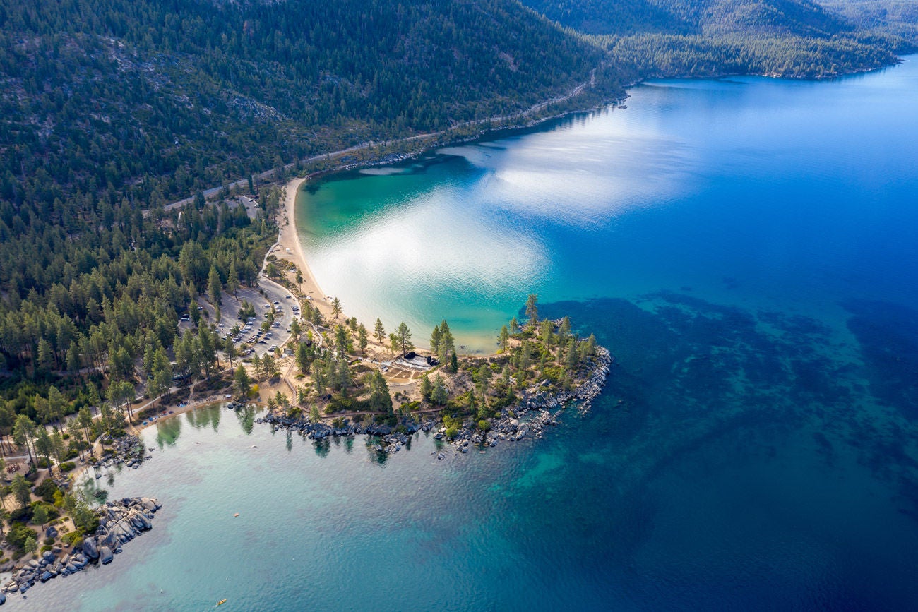 Aerial View of Lake Tahoe Shoreline with Mountains and Turquoise Blue Waters
