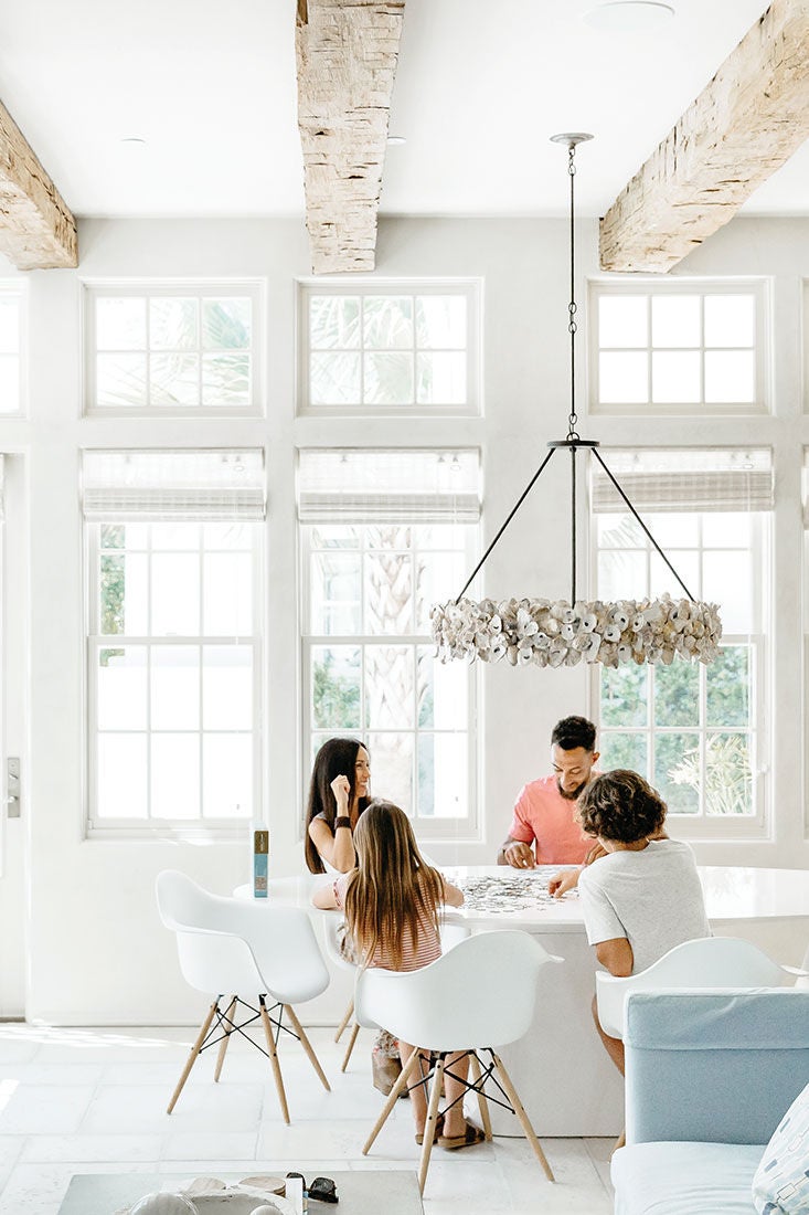 Family doing a puzzle at the table of a luxurious home